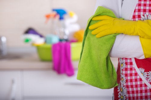 Technician performing detailed oven cleaning in a home kitchen