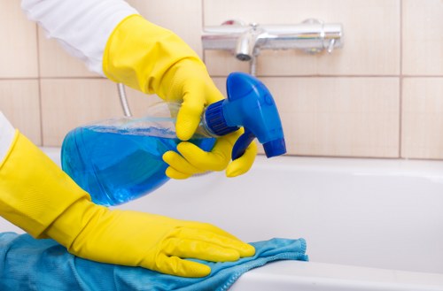 Cleaner wearing PPE during a professional deep cleaning task
